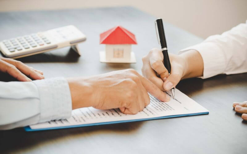 person siging real estate contract