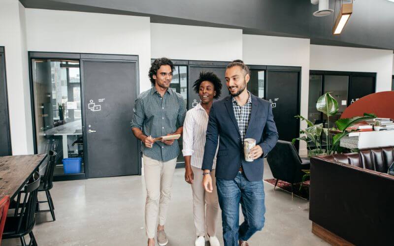 group of professionals walking through office space