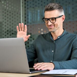 person waving to laptop in virtual meeting